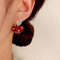 Close-up detail of the sparkling zircons and plating on the red heart earrings
