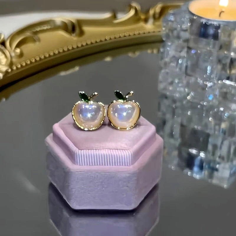 Close-up detail of the sparkling zircons and plating on the gold stud earrings