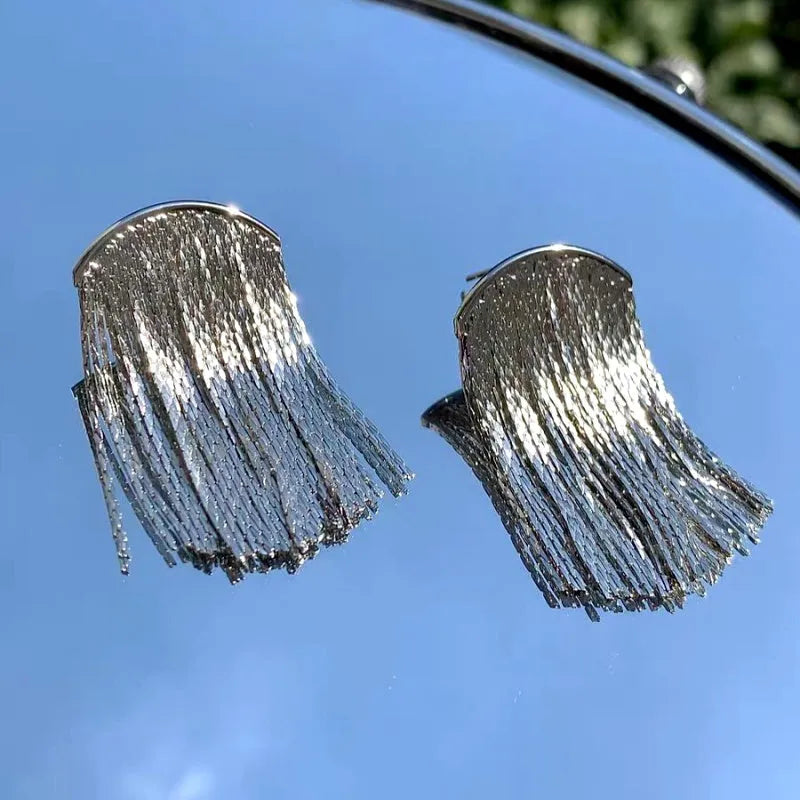 Close-up detail of the sparkling zircons and plating on the silver tassel earrings