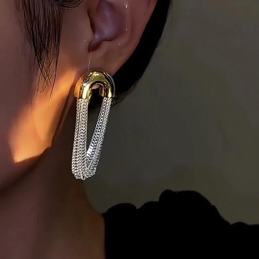 Model showcasing the dangle and style of the 14K Gold-Plated Arc Chain Tassel Earrings