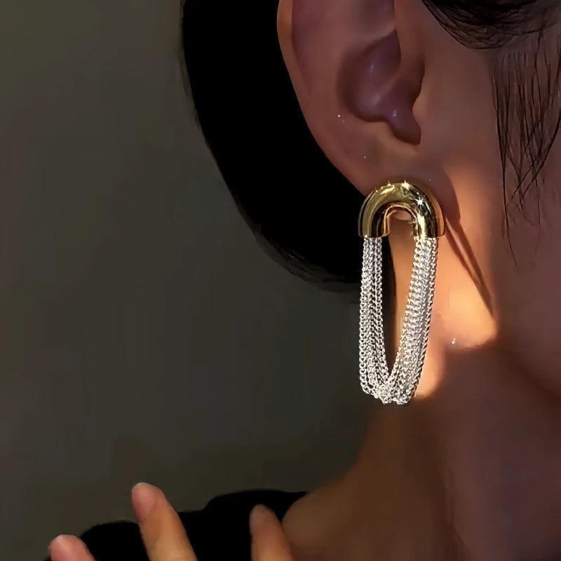 Close-up detail of the sparkling zircons and plating on the gold tassel earrings