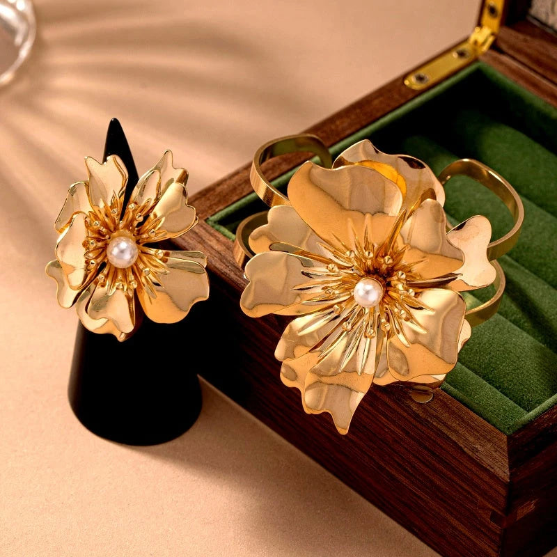 Close-up of the clasp and charm details on the gold flower bracelet