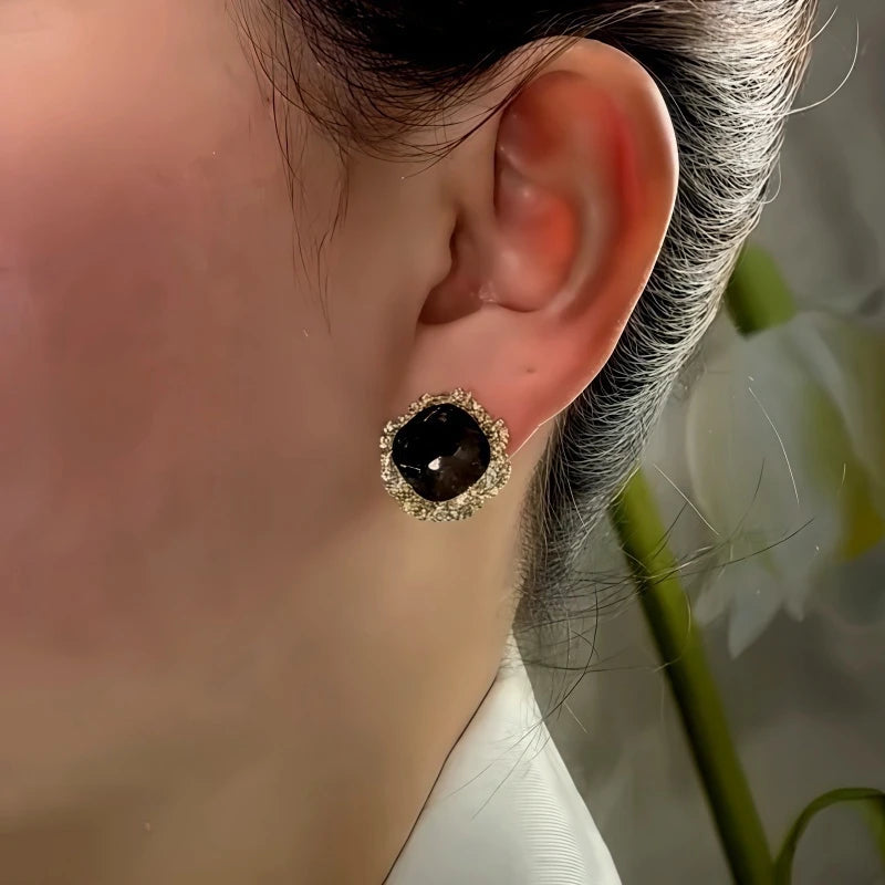 Close-up detail of the sparkling zircons and plating on the gold stud earrings