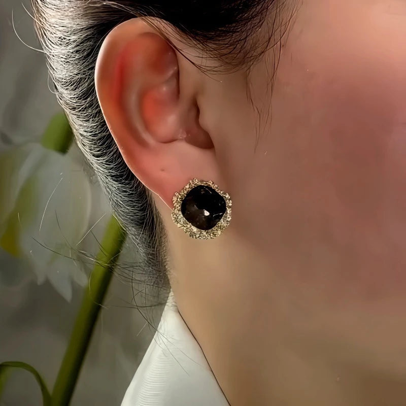 Model showcasing the dangle and style of the 14K Gold-Plated Balck Crystal Stud Earrings