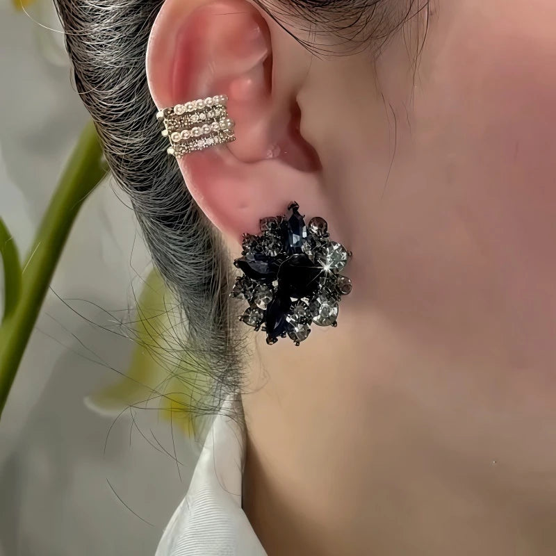 Model showcasing the dangle and style of the 14K Gold-Plated Balck Diamond Flower Stud Earrings