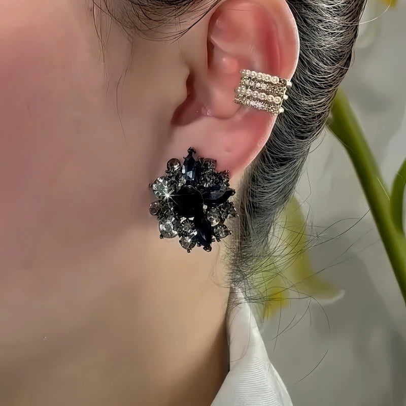 Close-up detail of the sparkling zircons and plating on the gold flower earrings