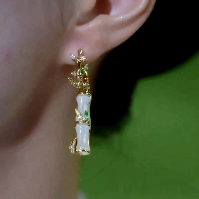 Model showcasing the dangle and style of the 14K Gold-Plated Bamboo Earrings