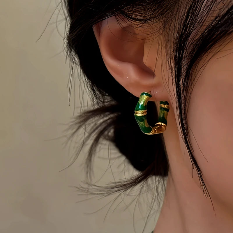 Model showcasing the dangle and style of the 14K Gold-Plated Bamboo Hoop Earrings