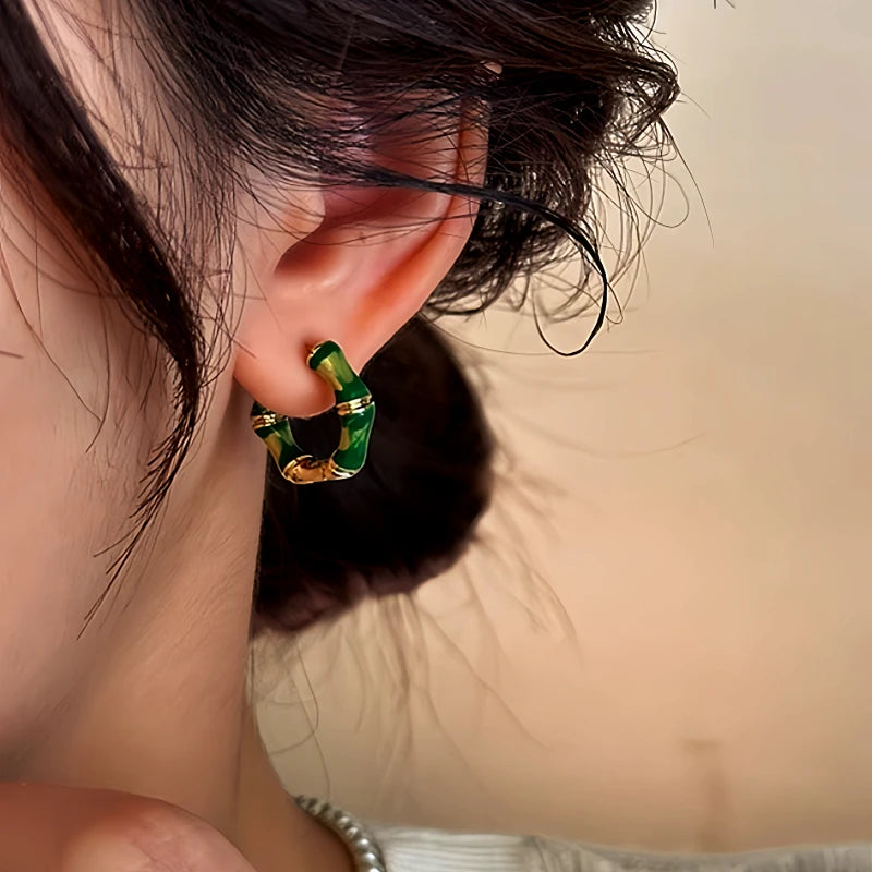 Close-up detail of the sparkling zircons and plating on the gold bamboo earrings