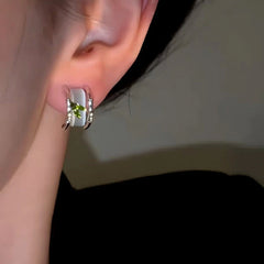 Model showcasing the dangle and style of the 14K Gold-Plated Bamboo Leaf Cat's Eye Earrings