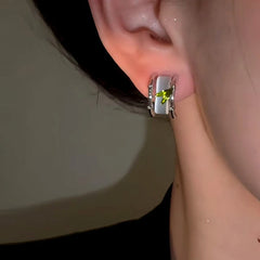 Close-up detail of the sparkling zircons and plating on the gold leaf earrings