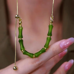 Close-up of the pendant and clasp on the gold bamboo necklace