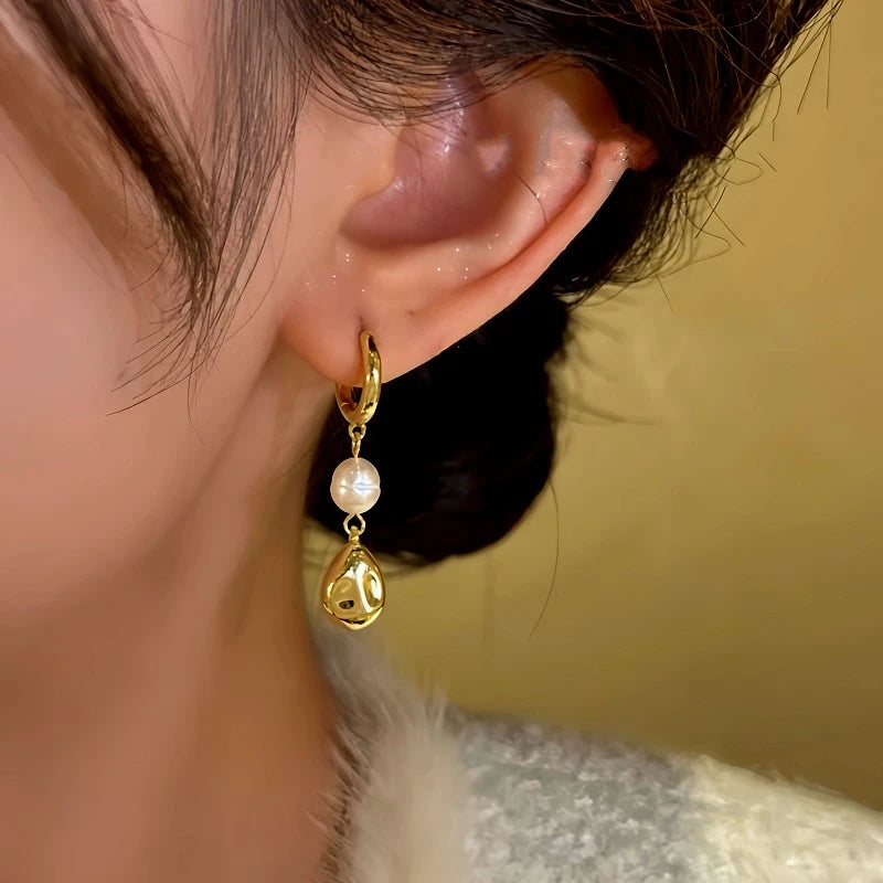 Model showcasing the dangle and style of the 14K Gold-Plated Bead Tassel Earrings