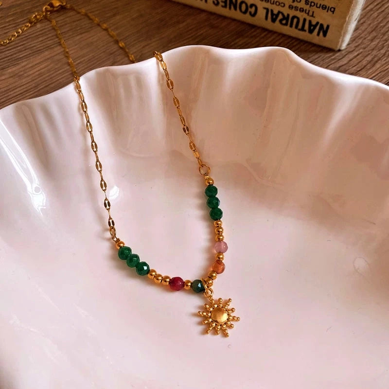 Close-up of the pendant and clasp on the gold sun necklace