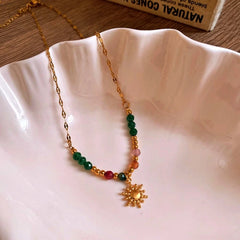 Close-up of the pendant and clasp on the gold sun necklace