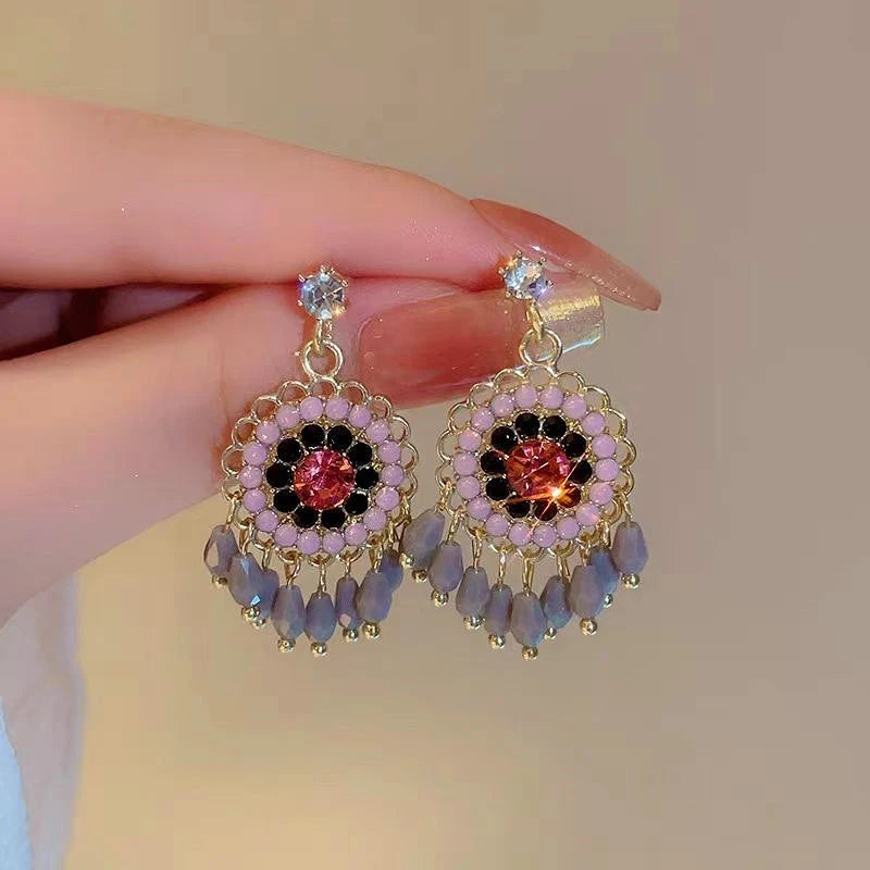 Angled view of the 14K Gold-Plated Beaded Tassel Earrings