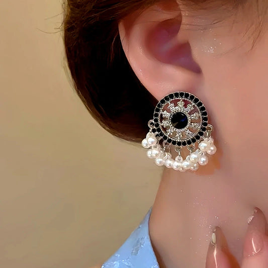 Model showcasing the dangle and style of the 14K Gold-Plated Beaded Tassel Earrings