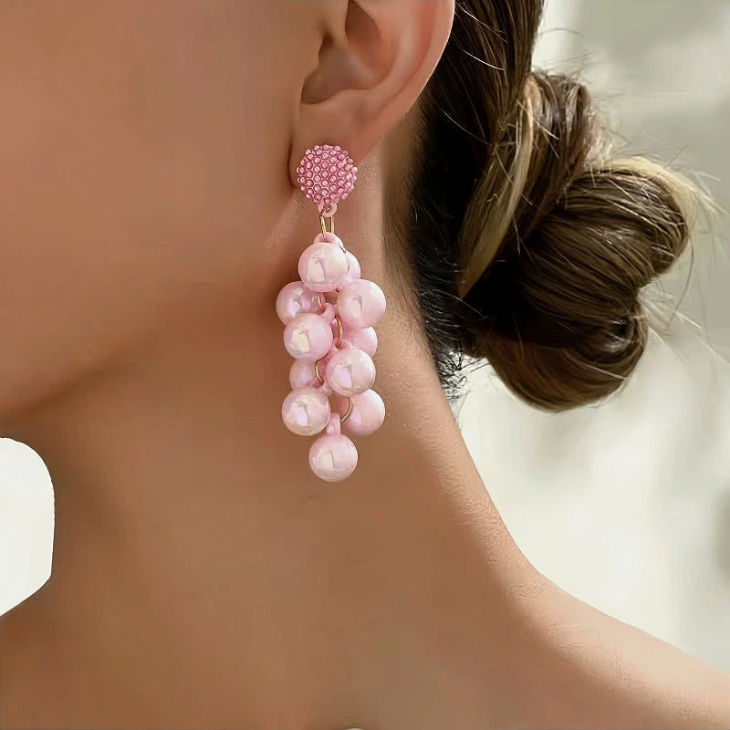 Model showcasing the dangle and style of the 14K Gold-Plated Beads Tassel Earrings