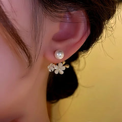 Model showcasing the dangle and style of the 14K Gold-Plated Beads Zircon Cat's Eye Flower Jacket Earrings