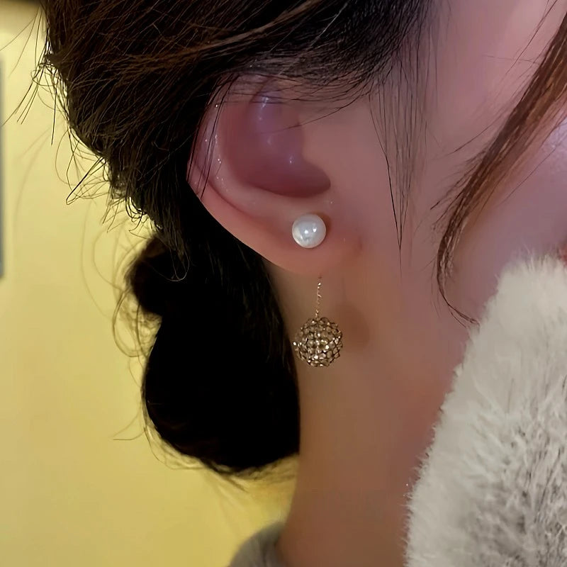 Close-up detail of the sparkling zircons and plating on the gold drop earrings