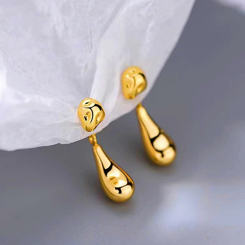 Close-up detail of the sparkling zircons and plating on the gold drop earrings
