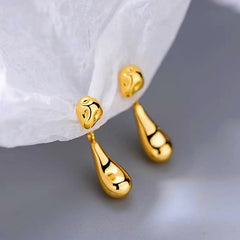 Close-up detail of the sparkling zircons and plating on the gold drop earrings
