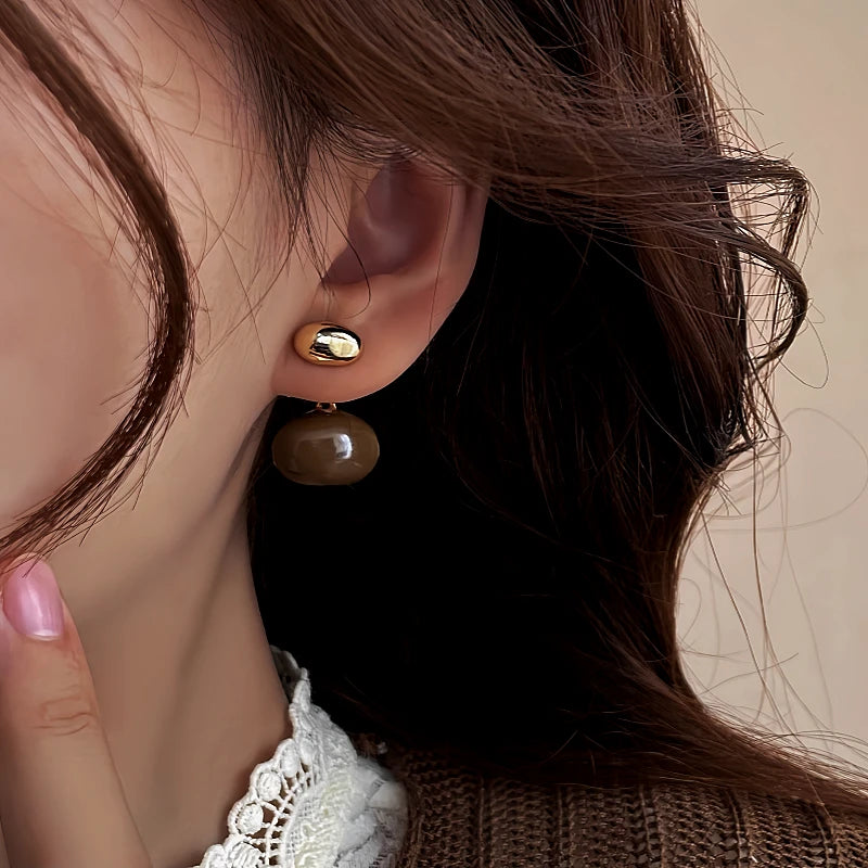 Angled view of the 14K Gold-Plated Bean Earrings