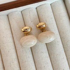 Styling the red drop earrings for a chic and modern look