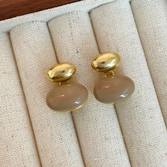 Detailed view of the sparkling accents on the red drop earrings