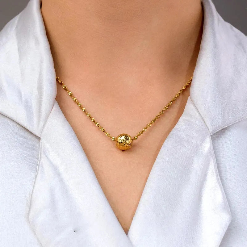 Close-up of the pendant and clasp on the gold pendant necklace
