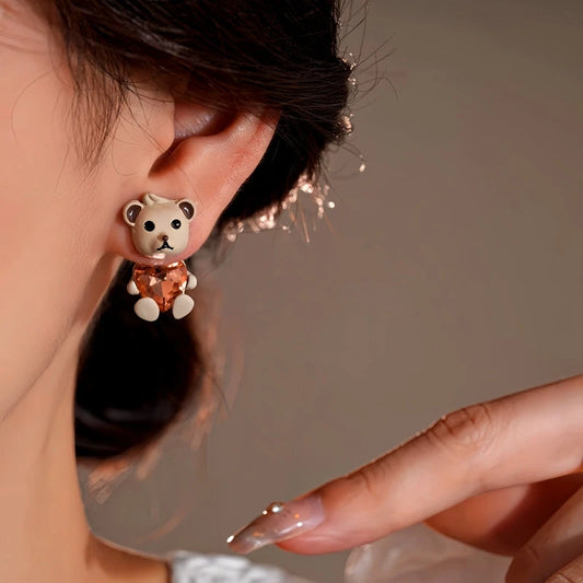 Model showcasing the dangle and style of the 14K Gold-Plated Beart In Love Heart Earrings