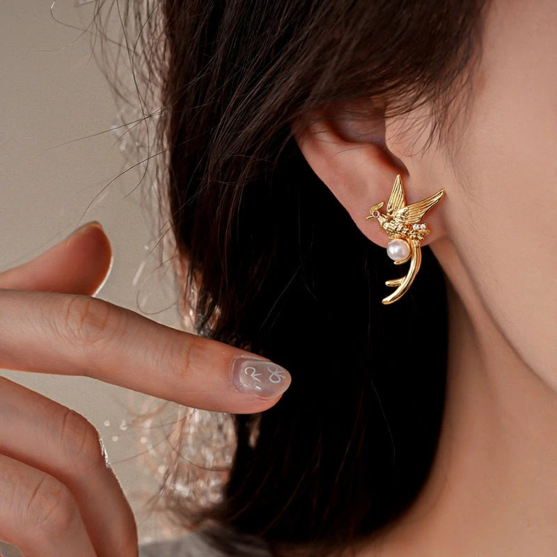 Close-up detail of the sparkling zircons and plating on the gold pearl earrings