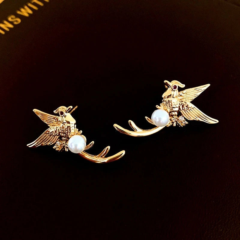 Angled view of the 14K Gold-Plated Bird Pearl Stud Earrings