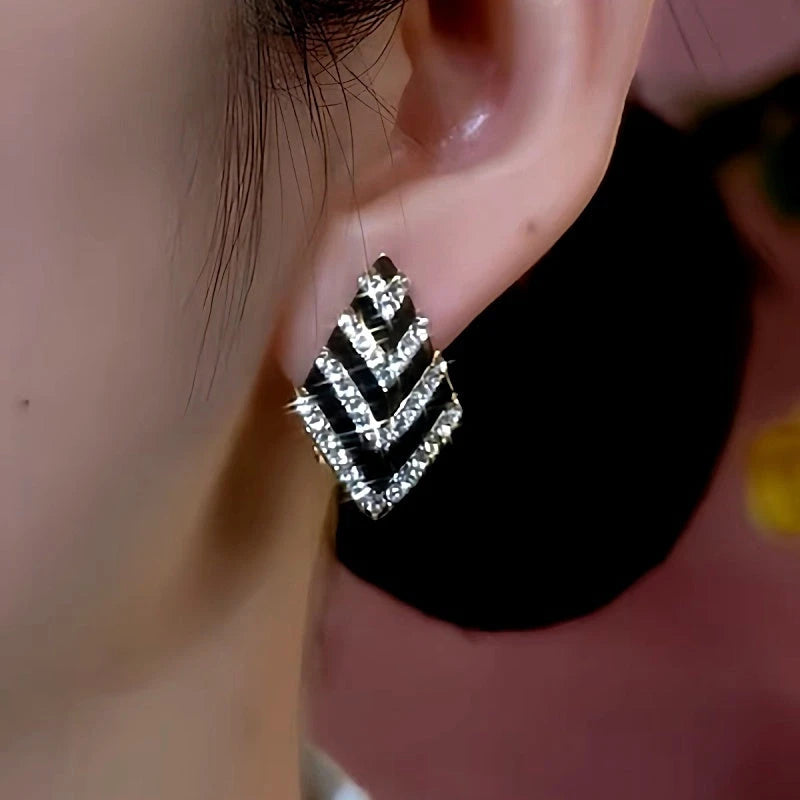 Close-up detail of the sparkling zircons and plating on the gold drop earrings