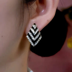 Close-up detail of the sparkling zircons and plating on the gold drop earrings