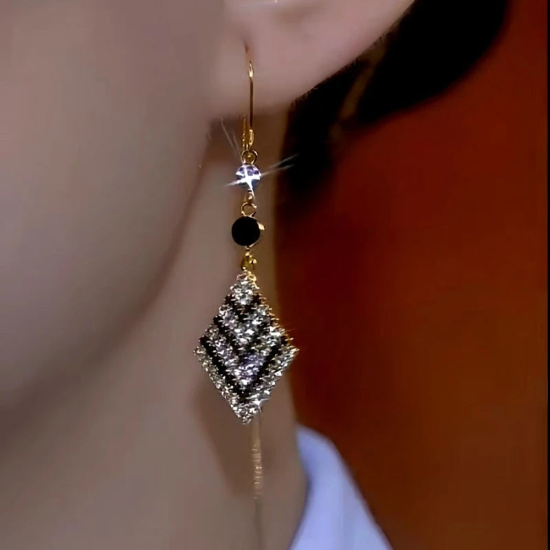 Close-up detail of the sparkling zircons and plating on the gold threader earrings
