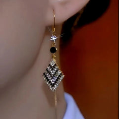 Close-up detail of the sparkling zircons and plating on the gold threader earrings