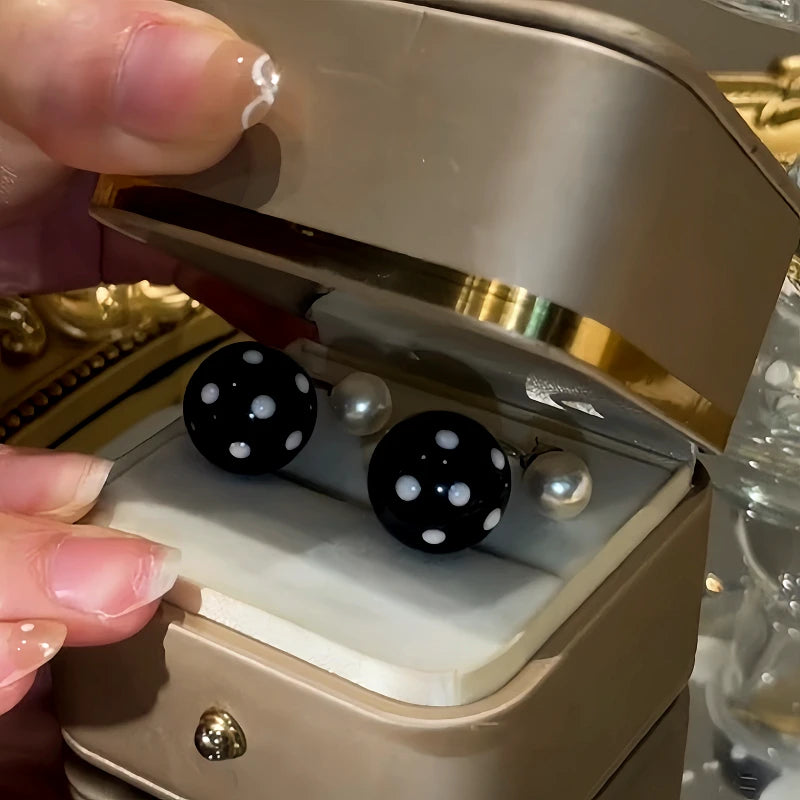 Close-up detail of the sparkling zircons and plating on the gold pearl earrings