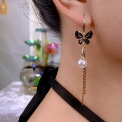 Close-up detail of the sparkling zircons and plating on the gold tassel earrings