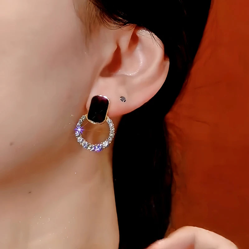 Close-up detail of the sparkling zircons and plating on the gold hoop earrings