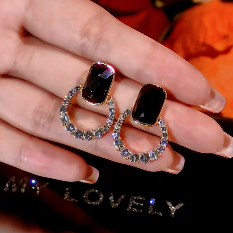 Angled view of the 14K Gold-Plated Black Crystal Hoop Diamond Earrings