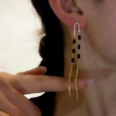 Close-up detail of the sparkling zircons and plating on the gold tassel earrings