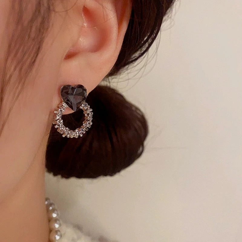 Close-up detail of the sparkling zircons and plating on the Heart Hoop Earrings