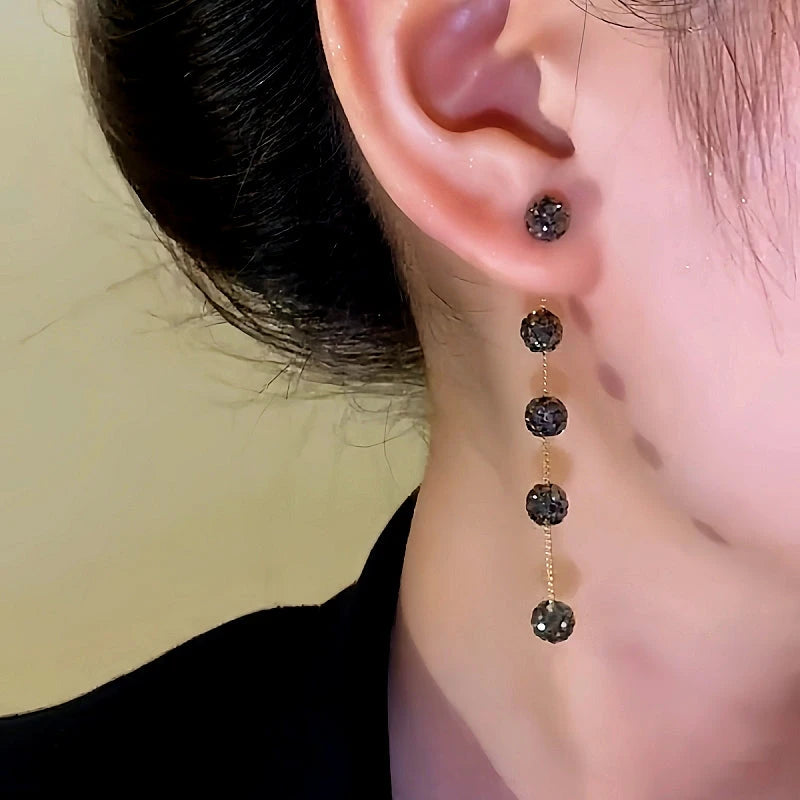 Close-up detail of the sparkling zircons and plating on the Long Tassel Earrings