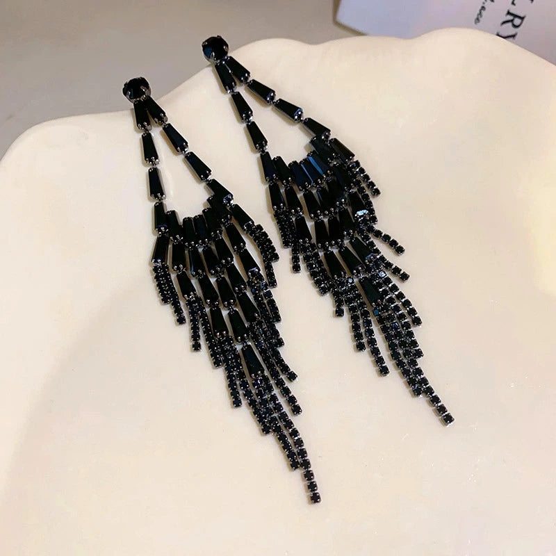 Angled view of the 14K Gold-Plated Black Diamond Tassel Earrings