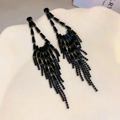 Angled view of the 14K Gold-Plated Black Diamond Tassel Earrings