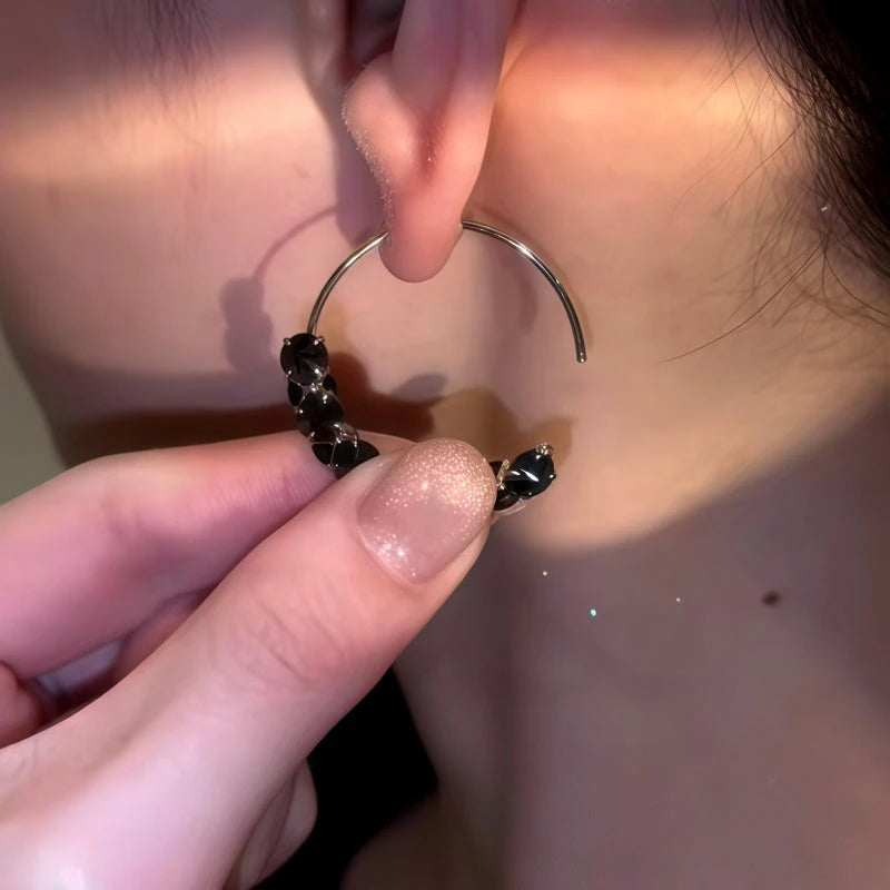 Model showcasing the dangle and style of the 14K Gold-Plated Black Diamond Threader Earrings