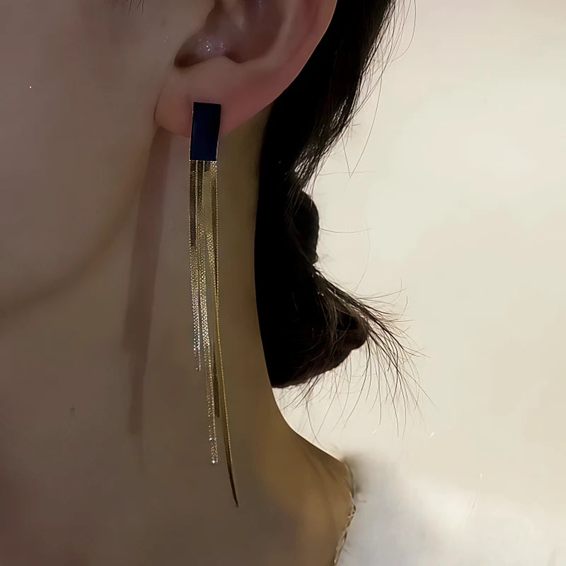 Model showcasing the dangle and style of the 14K Gold-Plated Black Jade Tassel Earrings