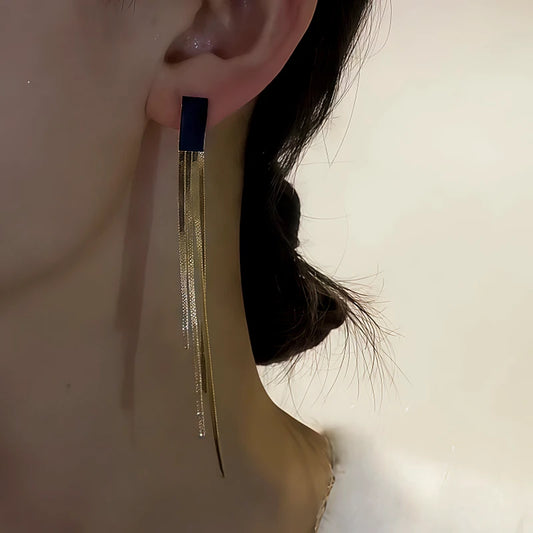 Model showcasing the dangle and style of the 14K Gold-Plated Black Jade Tassel Earrings