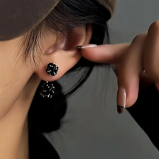 Model showcasing the dangle and style of the 14K Gold-Plated Black Zircon Ball Earrings